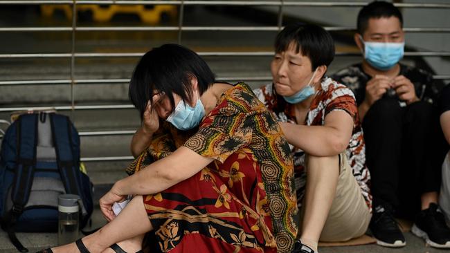 This photo taken on September 16, 2021 shows a woman crying as people gather at the Evergrande headquarters in Shenzhen amid rumours it is about to go under. Picture: Noel Celis/AFP