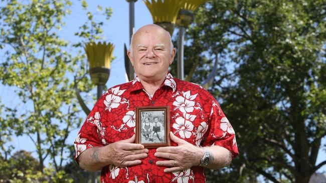 Peter Arbon with a photo of himself and his twin sister Ellen, aged around 5, at the Memorial to Forgotten Australians in North Adelaide. Picture: Emma Brasier