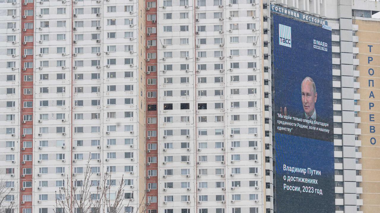 Election poster for Vladimir Putin on the side of a residential building. Picture: AFP