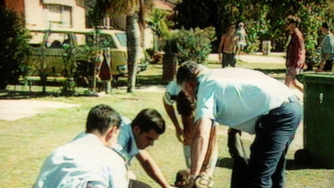 An injured person is tended to after a shooting at Tugun.