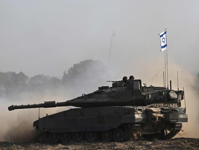 An Israeli Merkava tank is deployed with other armoured vehicles along Israel's border with Gaza. Picture: AFP