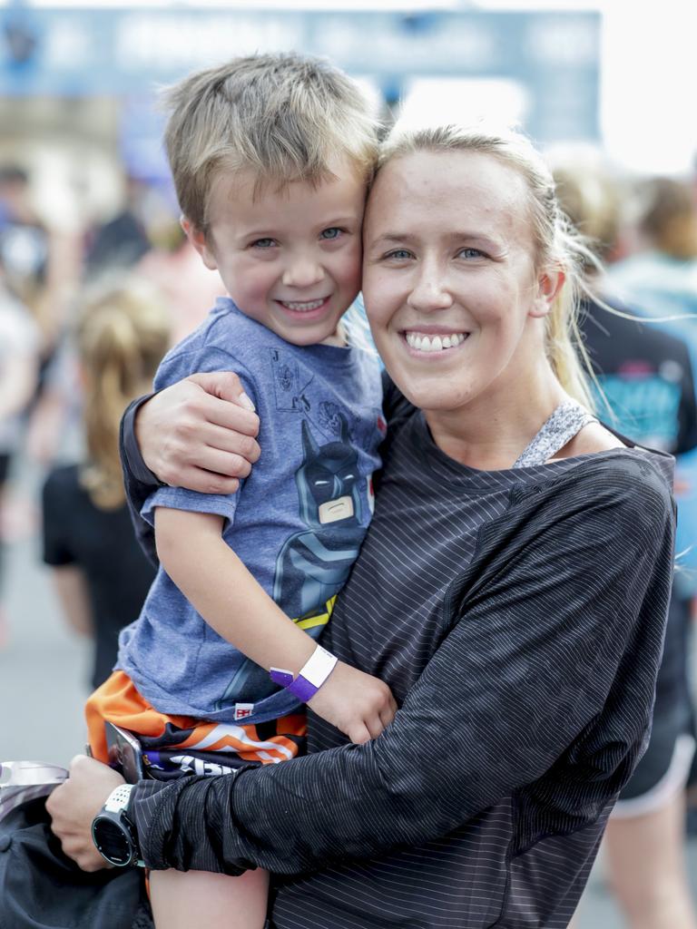 Kyson, 5, and Steph Davidson from Tweed Heads cuddle up at the finish of the Two Kilometre Junior Dash. Picture: Tim Marsden.