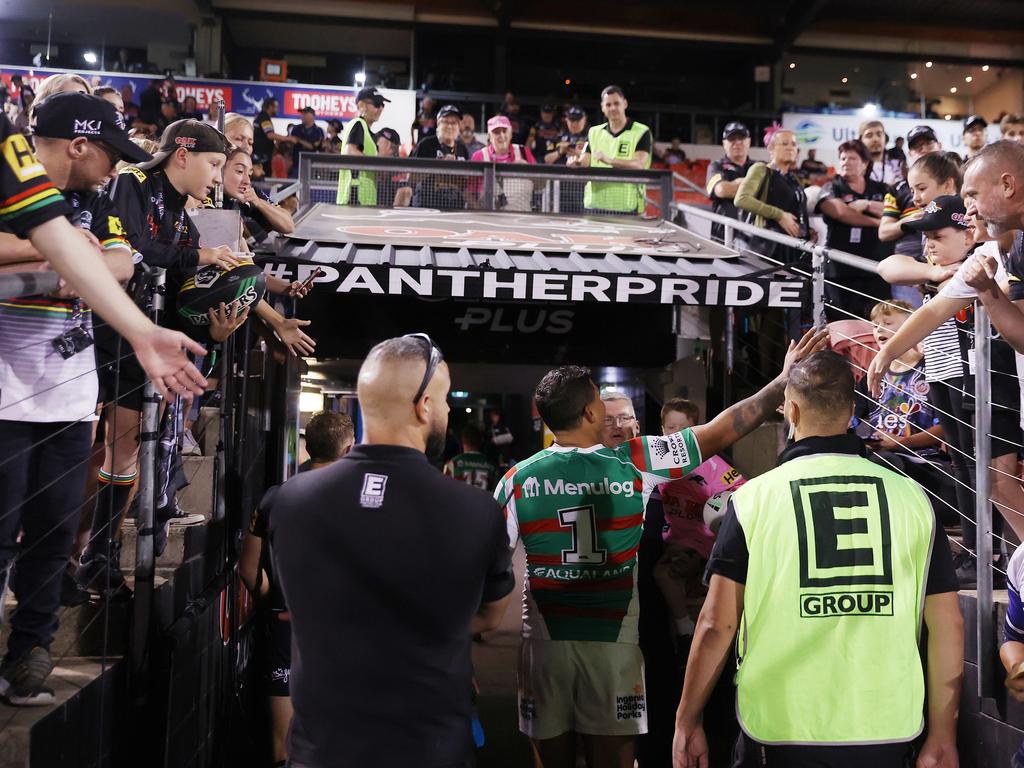 Latrell Mitchell of the Rabbitohs interacts with fans as he walks down the tunnel.