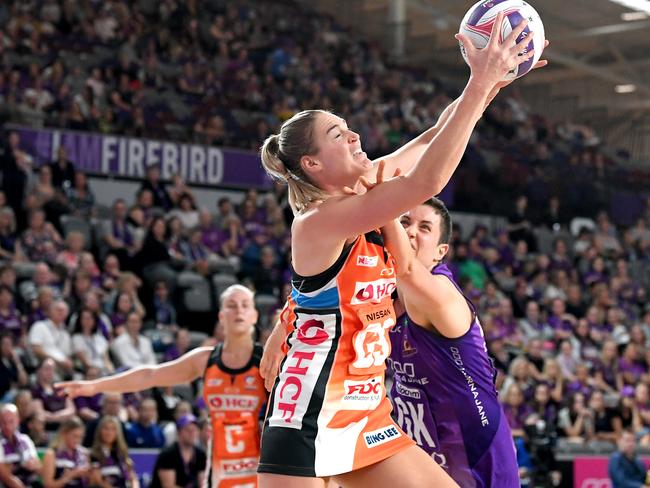 BRISBANE, AUSTRALIA - MAY 19: Caitlin Bassett of the Giants and Laura Clemesha of the Firebirds challenge for the ball during the round 4 Super Netball match between the Firebirds and Giants at Brisbane Arena on May 19, 2019 in Brisbane, Australia. (Photo by Bradley Kanaris/Getty Images)