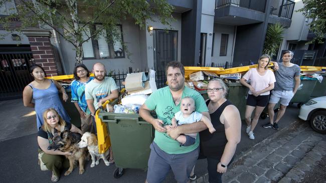 Adam and Kathleen Promnitz with their son, Xavier, 8 months, and other residents in Abbottsford who are upset at overflowing recycling bins. Picture: David Geraghty