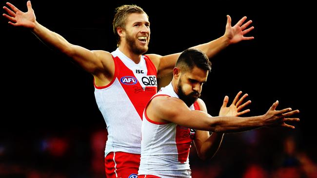 Lewis Jetta (R) performs an indigenous dance in honour of Adam Goodes after kicking a goal.