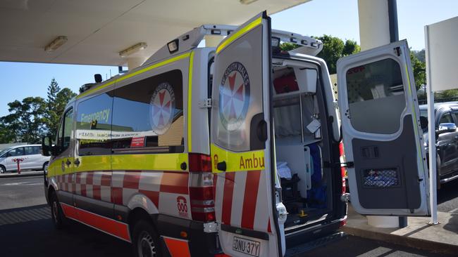 A NSW Ambulance waits outside a hospital.