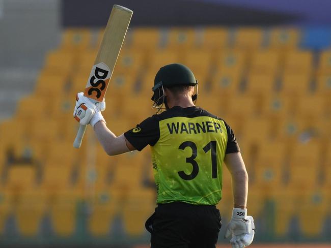 Australia's David Warner celebrates after scoring a half-century (50 runs) during the ICC menâs Twenty20 World Cup cricket match between Australia and West Indies at the Sheikh Zayed Cricket Stadium in Abu Dhabi on November 6, 2021. (Photo by INDRANIL MUKHERJEE / AFP)