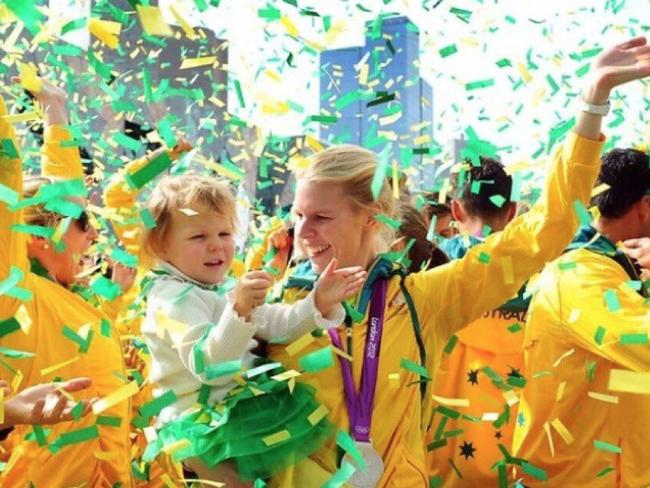 Sarah with one of her children celebrating her win in London