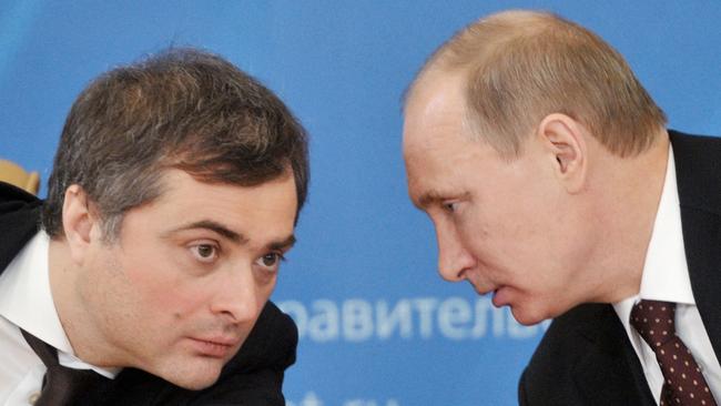 FILE - In this Feb. 13, 2012 file photo, , Russian Prime Minister Vladimir Putin, right, speaks to Vladislav Surkov, deputy prime minister in charge of economic modernization, during a visit in Kurgan, Russia. Surkov wrote in an article for Russia in Global Affairs magazine released Monday, April 9, 2018 that Russia has abandoned its centuries-long aspirations of integrating into the West and is bracing up for a new era of "geopolitical loneliness." (Alexei Nikolsky/RIA Novosti Kremlin via AP)