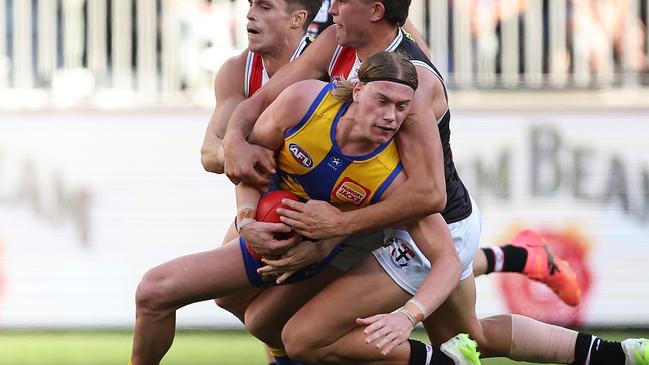 PERTH, AUSTRALIA - JUNE 01: Harley Reid of the Eagles gets tackled by Jack Steele and Rowan Marshall of the Saints during the round 12 AFL match between West Coast Eagles and St Kilda Saints at Optus Stadium, on June 01, 2024, in Perth, Australia. (Photo by Paul Kane/Getty Images)