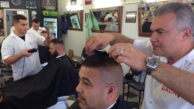 Bankstown Barber Salon owner Abdul Kandakji gives a customer a cool haircut. Picture: Antony Field