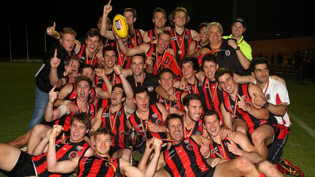 Rostrevor Old Collegians celebrate claiming the 2013 division one flag at Thebarton Oval. ROC drew with Salisbury North in the first grand final before going on to win the replay the following week. Picture: Stephen Laffer