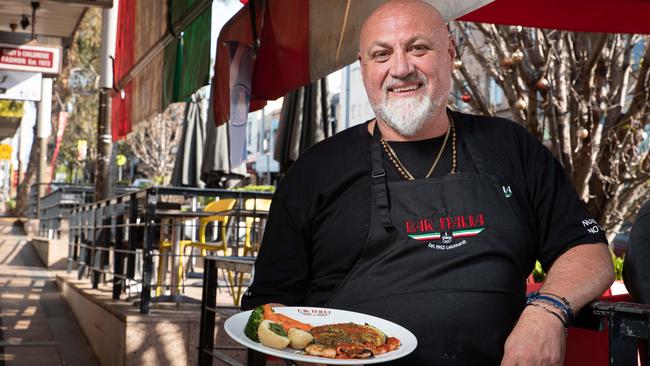 The owner of Bar Italia, Con Damouras, holding a chicken parmigiana. (Daily Telegraph / Flavio Brancaleone)