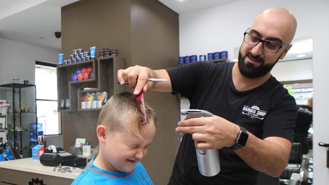 Jel’z Barber Shop owner Michael Nagi prepares the front of Cooper Pamment’s hair for spikes. Picture: Rob Pozo