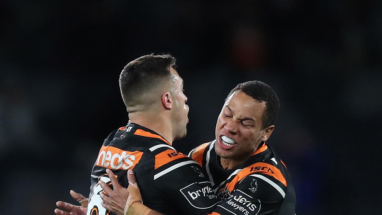 Tigers Luke Brooks celebrates with Tigers Moses Mbye after kicking the winning field goal during the Wests Tigers v Bulldogs NRL match at Bankwest Stadium, Parramatta. Picture: Brett Costello