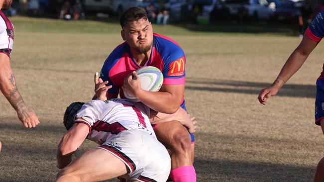 GCDRU (Gold Coast Rugby) first grade clash between Helensvale Hogs (pink) and Nerang Bulls. (white). Reno Gerrard runs into Tazzy Jones. Pic Mike Batterham