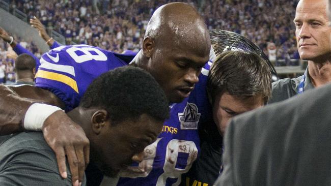 Adrian Peterson #28 of the Minnesota Vikings is carried into the locker room after injuring his knee.