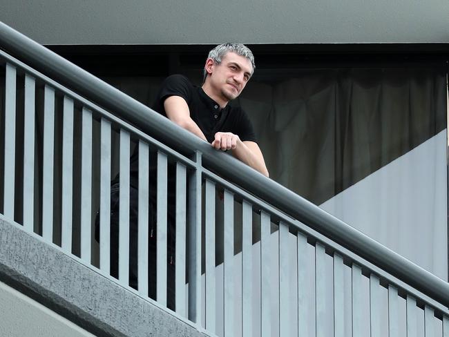 A man in quarantine standing on his balcony at the Hotel Grand Chancellor where new COVID-19 cases have been detected, Brisbane. Photographer: Liam Kidston