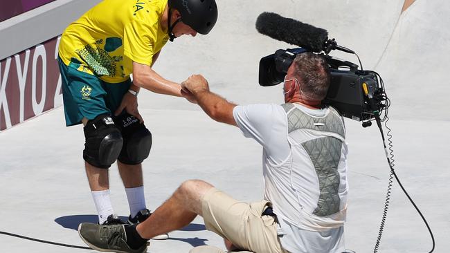 Woolley checks on a the cameraman and the pair exchange a fist pump after the crash. Picture: Jamie Squire/Getty Images