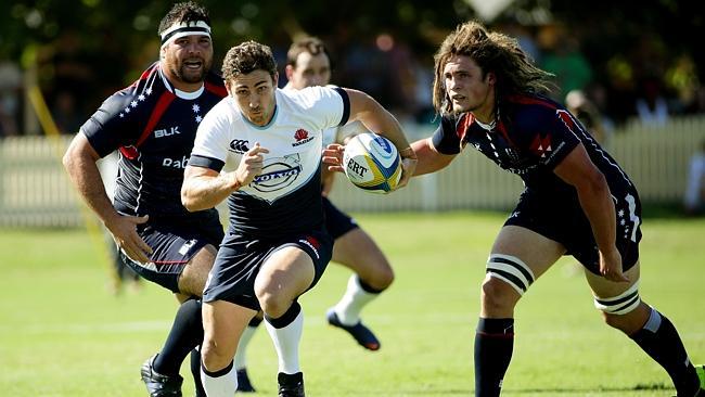 Waratahs scrumhalf Brendan McKibbin splits the Rebels defence and charges upfield.