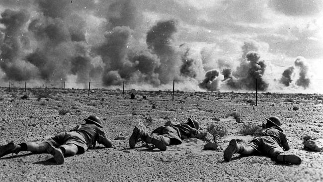 Australian soldiers crawl across the ground at the El Alamein battle in 1942 during World War Two. Picture: courtesy Australian War Memorial