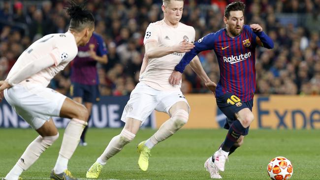 Barcelona’s Lionel Messi charges past Man United’s defence at the Nou Camp