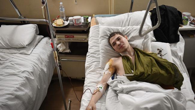 A 19-year-old Ukrainian soldier named Yevhen lays in bed in a military hospital in Lviv after being injured by a mine in the Luhansk region. Picture: AFP