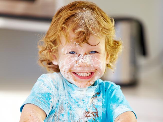 Little boy covered in baking ingredients after a baking session