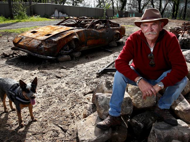 Lake Conjola resident Geoff Manias on his vacant block with dog Peppa and the remains of his beloved and rare 1972 Indy America Maserati. Picture: Toby Zerna