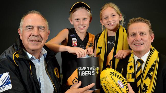 Glenelg Football Club legend Peter Carey, fans Joe, 11, and Summer, 12, with club president Nick Chigwidden at the launch of the Save the Tigers campaign in June. Picture: Bianca De Marchi.