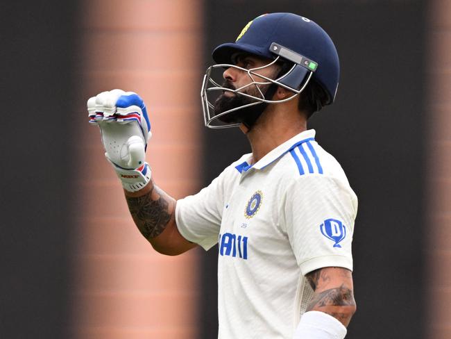 Indian batsman Virat Kohli walks off after been dismissed by Australian bowler Mitchell Starc on the first day of the second cricket Test match between Australia and India at the Adelaide Oval in Adelaide on December 6, 2024.  (Photo by William WEST / AFP) / --IMAGE RESTRICTED TO EDITORIAL USE - STRICTLY NO COMMERCIAL USE--