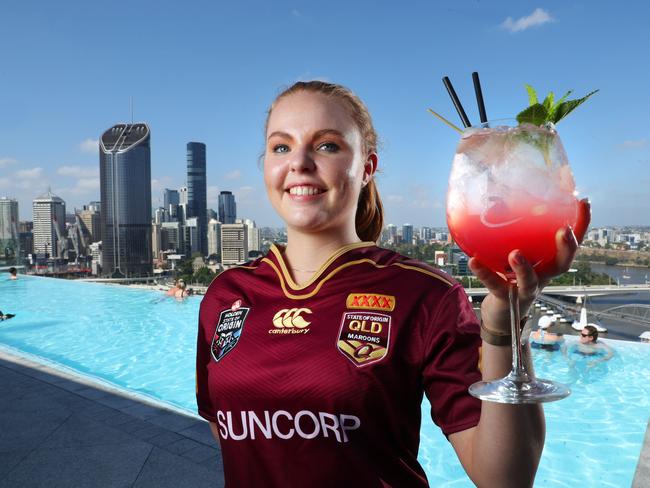 MUST CREDIT EMPORIUM HOTEL -  Aleisha Hamilton, 21 of South Brisbane, preparing for the State of Origin final with a pool side Emporium "Queenslander" cocktail, South Brisbane. Photographer: Liam Kidston.