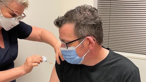 Andrews receives a Covid vaccine for the cameras.