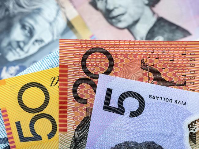 Australian money background.  Focus on foreground, blurred faces beneath. Notes generic