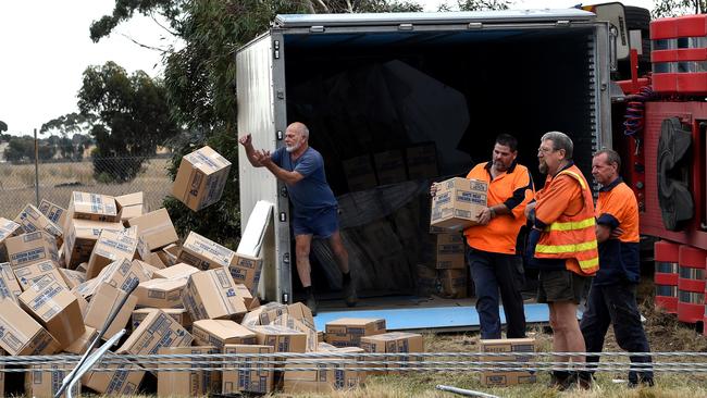 Workers clear boxes of chicken nuggets from a truck. Picture: Nicole Garmston