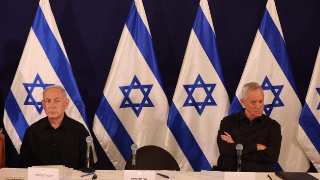 Seated far apart, Israeli Prime Minister Benjamin Netanyahu and war cabinet minister and political rival Benny Gantz attend a press conference in the Kirya military base in Tel Aviv last October. Picture: Abir Sultan / POOL / AFP