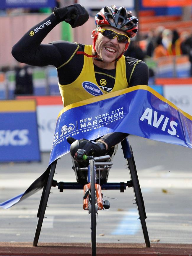 Kurt Fearnley breaks the tape to win the New York City Marathon in 2008. Picture: AP Photo/Kathy Willens