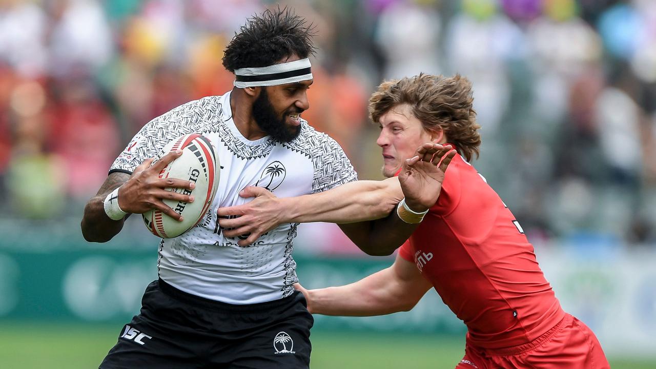 Semi Kunatani of Fiji fights off Vladislav Sozonov of Russia in Hong Kong.