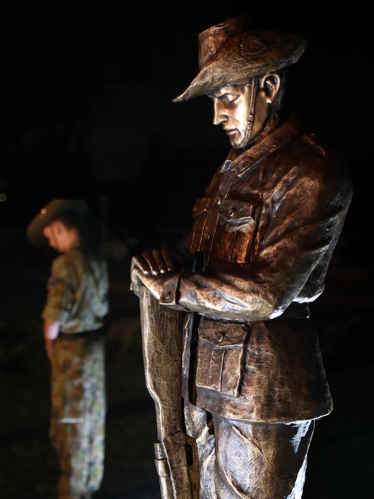 A Blacktown 202 Army Cadet unit member stands to attention with a statute at the Anzac Day dawn service at Pinegrove Memorial Park in Minchinbury. Picture: Angelo Velardo