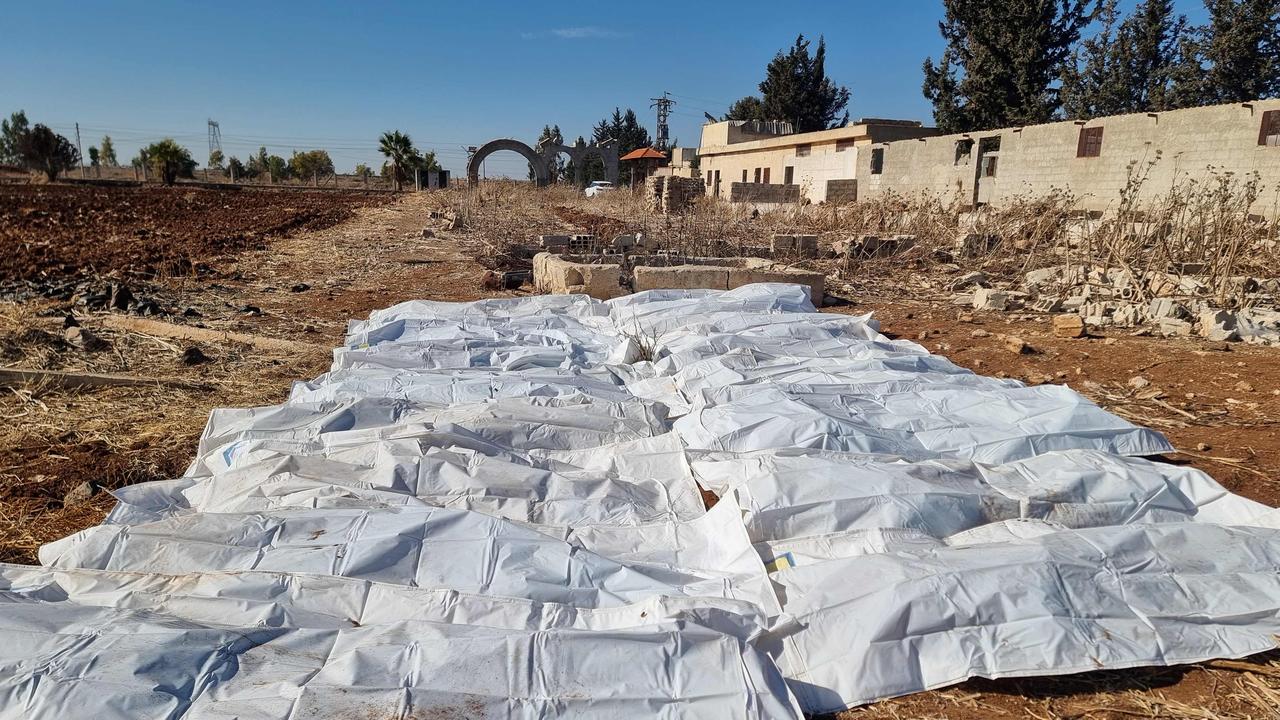 Body bags lie on a field after a mass grave was discovered in an agricultural land in Izra, in Syria's southern Daraa province, on December 16, 2024. Picture: Sam Hariri/AFP