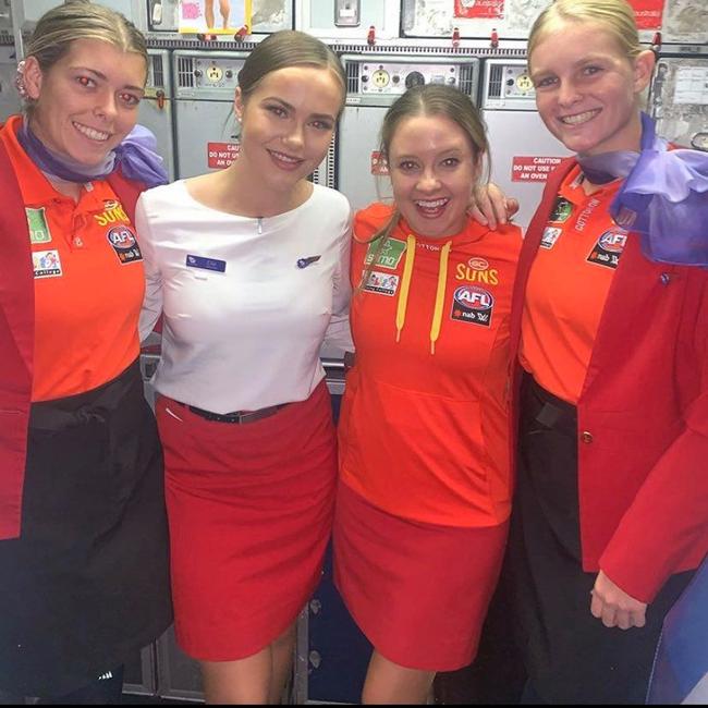 Kalinda Howarth and Serene Watson swap outfits with Virgin Australia hosties. SUPPLIED