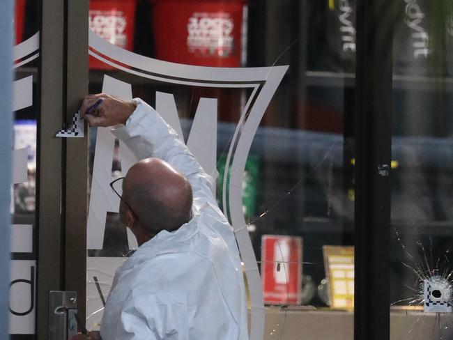 Police forensic teams scouring the gym where Omar was shot dead. Police are still hunting his killers. Picture John Grainger