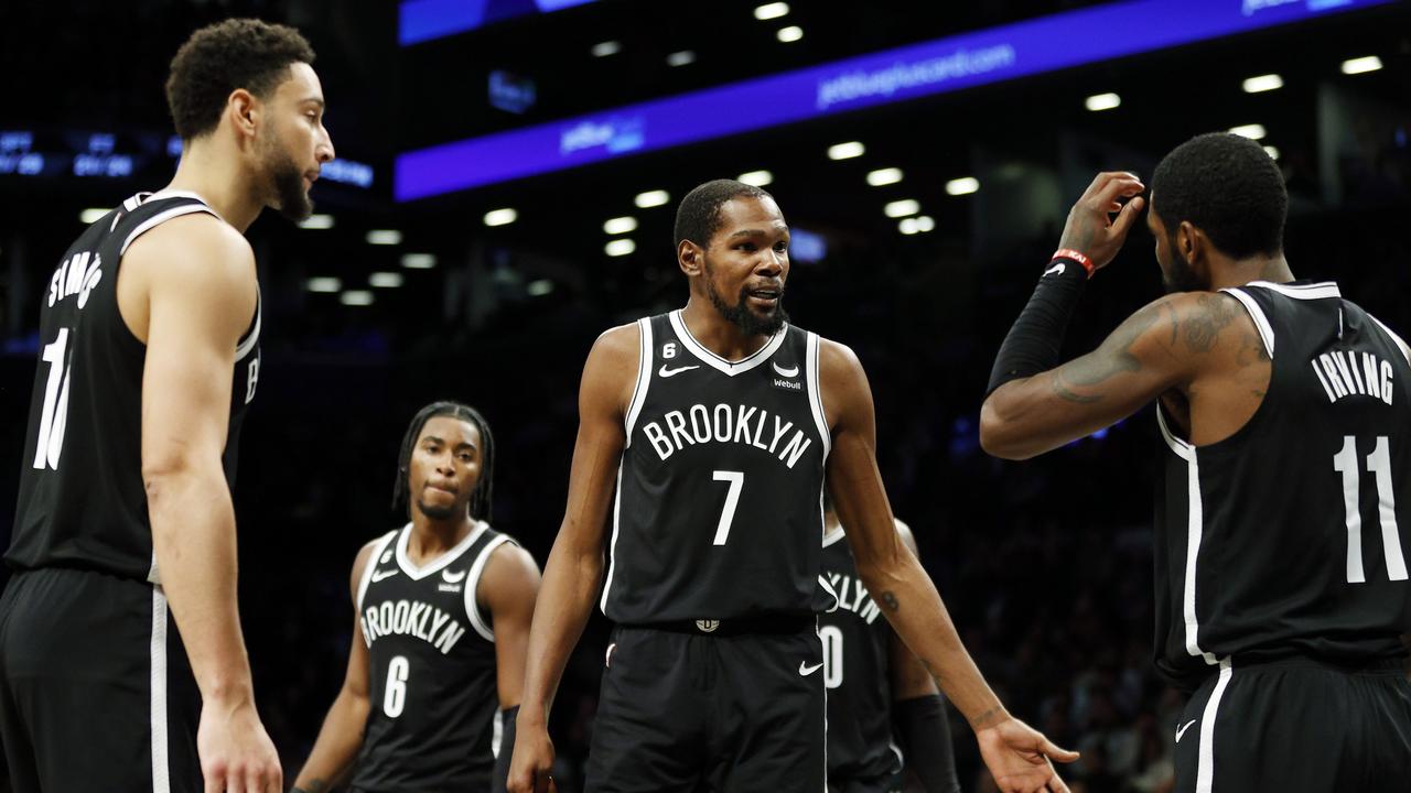 NEW YORK, NEW YORK - OCTOBER 27: Kevin Durant #7 talks with Ben Simmons #10 and Kyrie Irving #11 of the Brooklyn Nets during the second half against the Dallas Mavericks at Barclays Center on October 27, 2022 in the Brooklyn borough of New York City. The Mavericks won 129-125. NOTE TO USER: User expressly acknowledges and agrees that, by downloading and or using this photograph, User is consenting to the terms and conditions of the Getty Images License Agreement. (Photo by Sarah Stier/Getty Images)