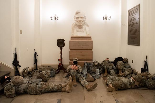 Members of the National Guard take a rest in the Rotunda of the US Capitol in Washington, DC, January 13, 2021, ahead of an expected House vote impeaching US President Donald Trump. - The Democrat-controlled US House of Representatives on Wednesday opened debate on a historic second impeachment of President Donald Trump over his supporters' attack of the Capitol that left five dead.Lawmakers in the lower chamber are expected to vote for impeachment around 3:00 pm (2000 GMT) -- marking the formal opening of proceedings against Trump. (Photo by SAUL LOEB / AFP)