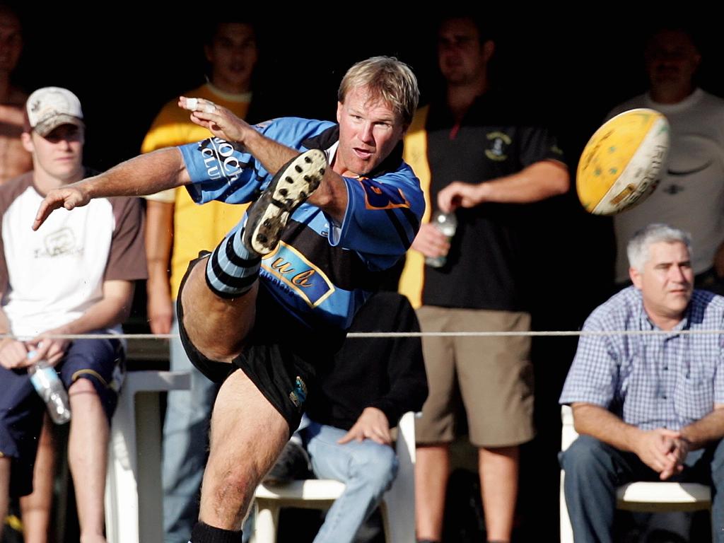 Maroochydore scrumhalf Paul Stitt kicks the ball over a maul back in 2005. Photo: Nicholas Falconer