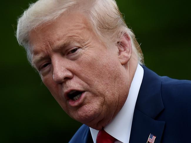 (FILES) In this file photo taken on May 27, 2020, US President Donald Trump walks across the South Lawn upon his return to the White House in Washington, DC. - Trump on May 28, 2020, marked the "sad milestone" of 100,000 coronavirus deaths in the US, after his earlier silence prompted criticism that he was failing in his duty to console victims and their loved ones. "We have just reached a very sad milestone with the coronavirus pandemic deaths reaching 100,000," Trump posted on Twitter, about 16 hours after the death toll passed the threshold according to a Johns Hopkins University tracker. (Photo by Olivier DOULIERY / AFP)