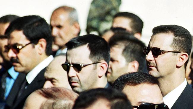 A file photo of Maher al-Assad, centre, with his brother, Syrian President Basher al-Assad, right, photographed at a funeral in 2000. Picture: AP