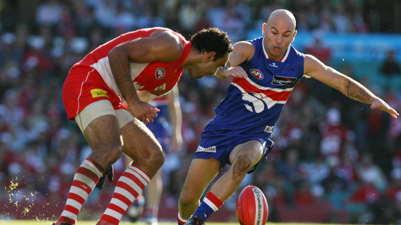 Nathan Eagleton, right, in his playing days for the Bulldogs, up against Sydney’s Adam Goodes. Picture: Sam Mooy.