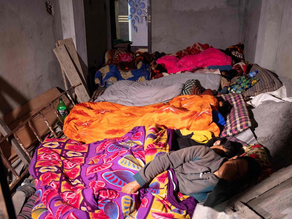 Residents rest under blankets after the quake. Picture: AFP